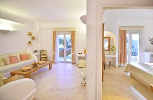 a living room with a couch and a table at Tamarix Del Mar Suites in Kamari