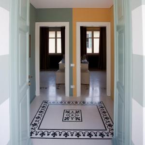 a hallway with doors and a rug on the floor at Tenuta Tamburnin in Castelnuovo Don Bosco