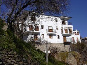 a white building on the side of a hill at Alojamiento Rural Mirador del Avellano in Alpujarra de la Sierra