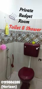 a bathroom with a purple toilet and a shower at Arina`s Homestay in Kuala Besut