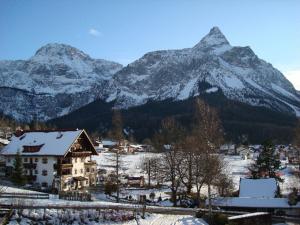 a house in front of a snow covered mountain at Ferienhaus Antonia in Ehrwald