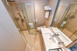 a bathroom with a sink and a shower and a toilet at Hotel Sirius in Jeju