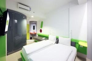 Ένα ή περισσότερα κρεβάτια σε δωμάτιο στο POP! Hotel Tanjung Karang