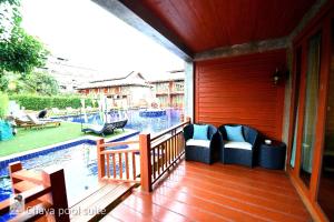 a porch with a pool and chairs on a house at The Chaya Resort and Spa in Chiang Mai