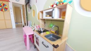 a toy kitchen with a sink and a counter at ChaoPingJia Fengge Guesthouse in Wujie