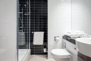 a bathroom with a shower and a toilet and a sink at Holiday Inn Express Middlesbrough - Centre Square, an IHG Hotel in Middlesbrough