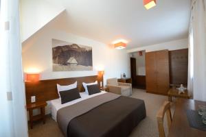 a bedroom with a large bed and a table at Pensjonat Orla Perc in Zakopane