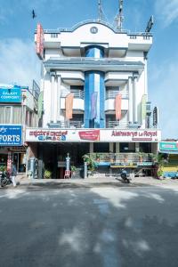 a large building with an entrance to a street at Aishwarya Le Royal in Mysore