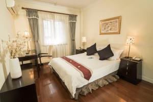 Postel nebo postele na pokoji v ubytování Ladoll Service Apartments