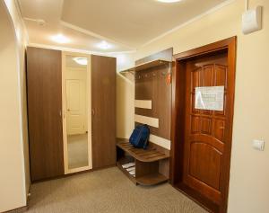 a room with a wooden floor and a wooden door at Hotel Khakasia in Abakan