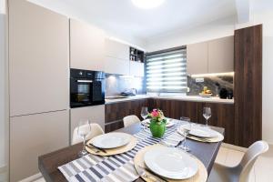 A kitchen or kitchenette at Sleeping Beauty Apartment City Center!!