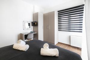 A bed or beds in a room at Sleeping Beauty Apartment City Center!!