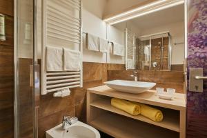 a bathroom with a sink and a toilet at Alpin Relais B&B Villa Melisse in Colfosco +86 photos