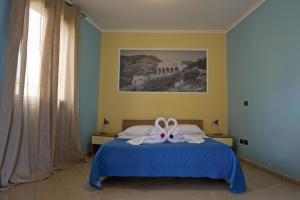 Кровать или кровати в номере Hotel Ristorante Al Canto delle Sirene
