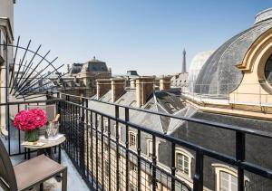 a balcony with a vase of flowers on a table at Grand H&ocirc;tel Du Palais Royal in Paris