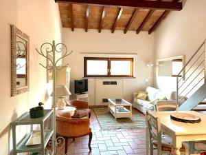 a living room with a couch and a table at Agriturismo Potrero Grande sul Lago di Martignano con spiaggia in Campagnano di Roma