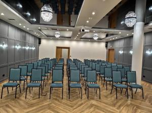 a large room with rows of chairs in a row at Hotel Szara Willa in Opole