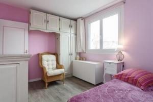 Un dormitorio con una cama y una silla y una ventana. en REFAIT A NEUF Appartement proche de Paris, en Asnières-sur-Seine