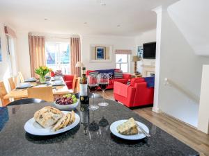 a living room with a table with food and wine glasses at Yardarm in Salcombe