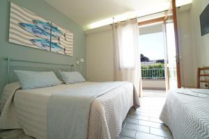 Postel nebo postele na pokoji v ubytování Hotel Residence La Ventola
