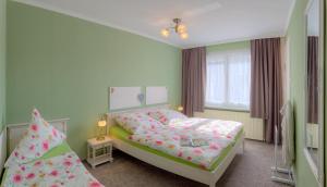 a small bedroom with a bed and a window at Ferienhaus "Steffan" in Trassenheide