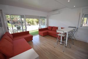 a living room with a red couch and a table at Castelldefels Playa in Castelldefels