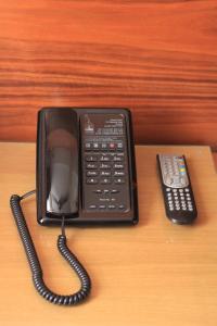 a remote control sitting on top of a wooden table at Sheriff Hotel in London