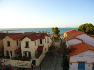 a city street with houses and the ocean in the background at Iracema Mar Hotel in Fortaleza