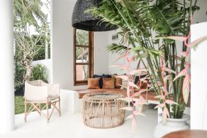 a living room with plants and a table and chairs at The Oasis Villa in Ahangama