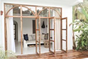 a room with a glass door and a couch at The Oasis Villa in Ahangama