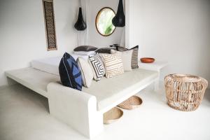 a white bench with pillows on it in a room at The Oasis Villa in Ahangama