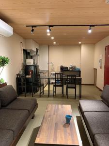 a living room with a couch and a table at Hilo Hostel in Nara