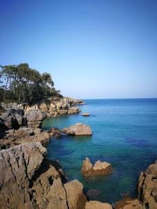 a large body of water with rocks in the water at Noja Playamar Apartment in Noja