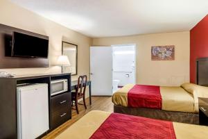 a hotel room with a bed, stove, microwave and refrigerator at Econo Lodge East Staunton in Staunton
