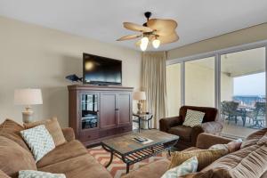 a living room with a couch and a tv at TOPS'L Tides II in Destin