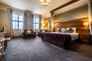
a bedroom with a large bed and a large window at Bridge Hotel in Greenford
