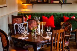 a table in a restaurant with wine glasses on it at The Carnarvon Arms in Newbury