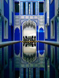 a blue and white room with chairs in the water at Riad Goloboy in Marrakesh