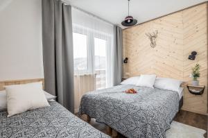 Posteľ alebo postele v izbe v ubytovaní Apartamenty Smrekowa Turnia