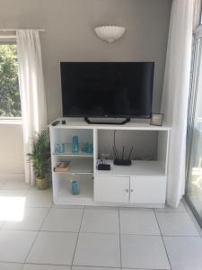 a white entertainment center with a flat screen tv on it at 9 Bronze Bay in Durban