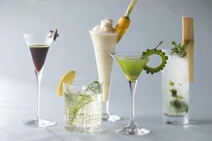 a group of four different cocktails on a table at Sheraton Okinawa Sunmarina Resort in Onna