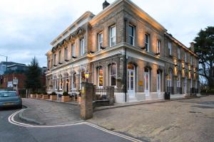 a large brick building on a city street at The Park Hotel in Teddington