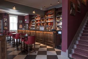 a bar with tables and chairs in a restaurant at The Park Hotel in Teddington