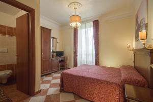 a hotel room with a bed and a bathroom at Hotel RomAntica in Rome