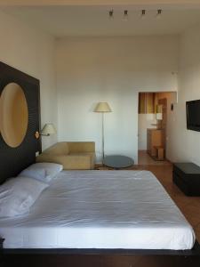 a bedroom with a large bed and a couch at Family Bungalow Pineta in Novigrad Istria
