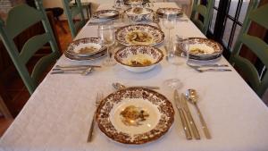 a table with plates of food and glasses and silverware at Romantic-HuntingLodge-en-Provence**** in Saint-Pierre