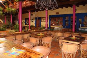 a dining room with wooden tables and chairs at La Vieja Casona Hotel in La Manzanilla