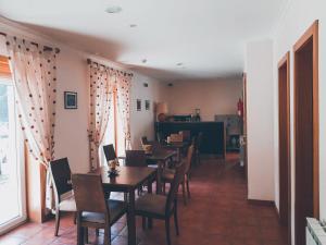 un comedor con mesas y sillas y una habitación con ventana en Casa Santa Catarina, en Montalegre