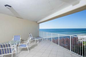 a balcony with a table and chairs and the ocean at TOPS'L Tides II in Destin