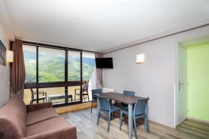 a living room with a couch and a table at SOWELL RESIDENCES Pierre Blanche in Les Menuires